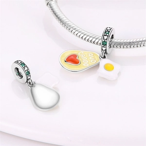 Silver avocado charm with AVO CAN DO engraving and egg pendant on snake chain bracelet