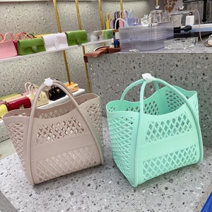 Hollow out jelly beach bags in beige and mint green colors on display shelves