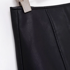 Front view of chic black PU leather skort with refined grain texture and stitching