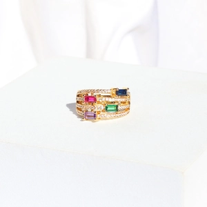 Detail of gold multi-layer ring with rectangular colorful gemstones and micro-pave crystals