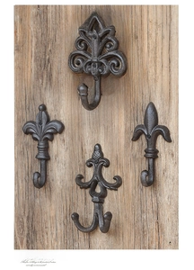 Detailed view of vintage industrial cast iron wall hooks mounted on aged wood texture