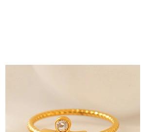 Detail of twisted rope gold band ring featuring a brilliant round-cut bezel-set zircon