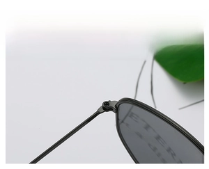 Detailed macro view of the reinforced metal hinges on black square frame sunglasses