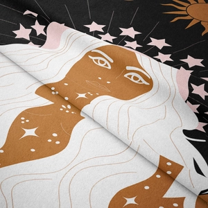 Detail shot of bohemian tapestry fabric showing soft texture and sun moon celestial print