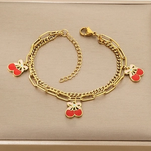 Double-layered golden bracelet featuring cherry pendants with red enamel details