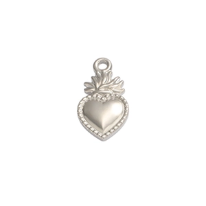 Detailed view of a silver heart-shaped pendant with flame motifs and beaded edges