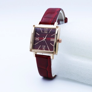 Detail of square quartz watch with red roman dial and rose gold metal case