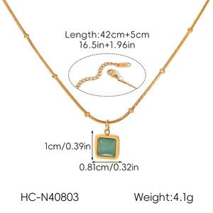 Detail of stainless steel necklace with green cat's eye pendant and measurement specs.