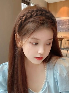 Detailed close-up of a dark brown fishtail braided headband made of synthetic hair