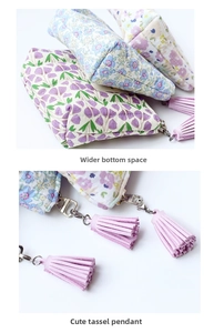 Close-up of quilted floral coin purse with tassel zipper and widened bottom for extra space
