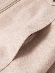 Detailed macro view of soft wool blend fabric with metallic zipper and side pocket