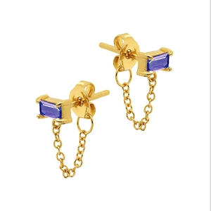 Detail of gold chain earrings featuring blue purple rectangular stones on white background
