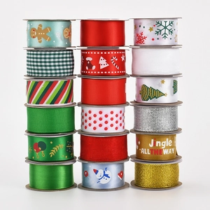 Close-up of assorted Christmas ribbons with gold foil patterns and festive textures