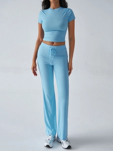 Detail of light blue ribbed fabric lounge set featuring crop top and drawstring flare pants