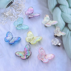 Colorful butterfly and rose hair clips in vibrant gradient resin on soft white background