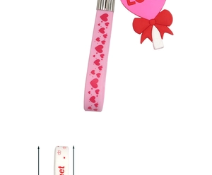 Detail of pink silicone heart keychain with LOVE pendant and red bow tie ornament