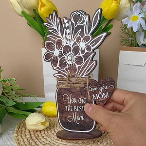 Detail of wooden Mother's Day flower pot decor with Love You Mom engraving and jute bow