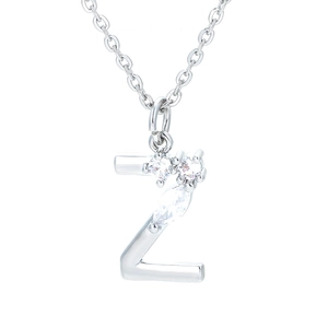 Macro detail of silver letter Z pendant with micro-inlaid sparkling zircon crystals