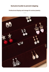 Detail view of walnut jewelry tray with red velvet slots for earring organization
