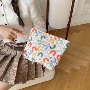 Close-up of soft quilted cotton makeup bag featuring colorful abstract floral patterns