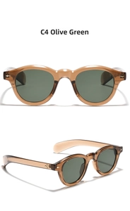Detail view of round retro sunglasses in amber frame with olive green lenses and star rivets