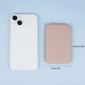 Pink PU leather folding portable makeup mirror shown beside a smartphone for size comparison