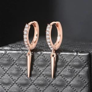 Close-up of rose gold cone drop earrings with sparkling pavé cubic zirconia inlay