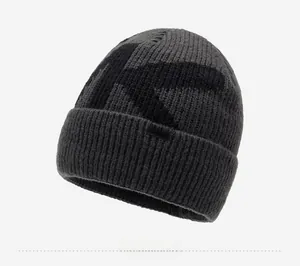 Detail shot of the thick knit texture and woven KYX DESIGN logo label on this beanie