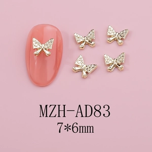 Detailed view of golden butterfly nail charms with rhinestones sized 7x6mm