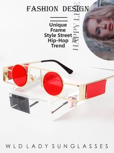 Detailed macro view of the gold geometric frame and red round lenses on hip hop sunglasses