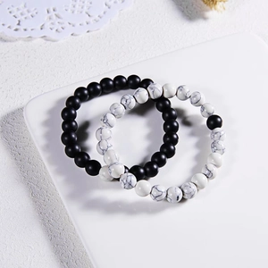Detail of 8mm matte black agate and white turquoise beaded bracelets for couples