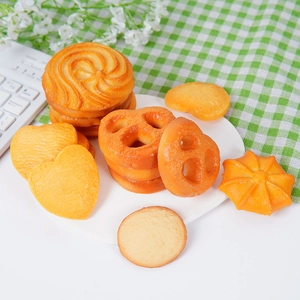 Realistic PVC cookie keychain collection with various shapes on a white plate