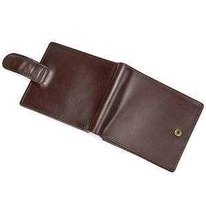 Detailed view of dark brown genuine leather wallet with metallic snap button closure