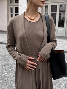 Detail of soft brown knitted long cardigan and matching top with premium texture