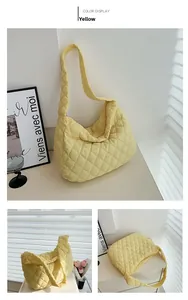 Macro detail of a yellow quilted tote bag with diamond pattern and soft shoulder strap