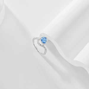 Detailed macro view of S925 silver ring featuring a blue pear-cut zircon and accent diamonds