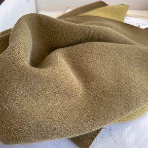 Close-up of brown twill pashmina fabric showing soft texture and thick cashmere-like weave