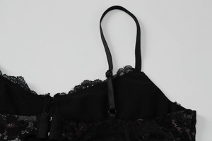 Detail of delicate lace trim and adjustable shoulder straps on the leopard print dress