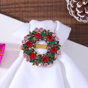 Detail of vintage gold Christmas wreath napkin ring with red and green crystals