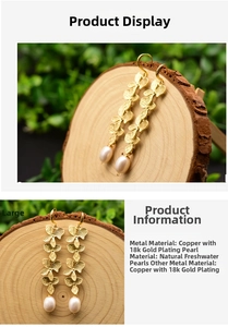 Detail of 18k gold plated floral earrings with natural freshwater drop pearls