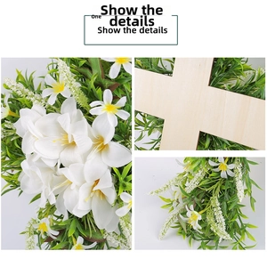 Close-up details of lily cross wreath with white artificial flowers and green foliage
