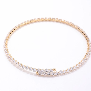 Macro detail of gold choker featuring square-cut zircons and elegant cross-over ends