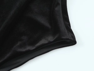 Close-up of black velvet bodysuit showing luxury fabric texture and premium stitching