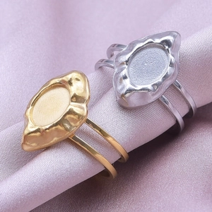 Macro detail of oval lava texture ring base in gold and silver on pink silk