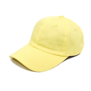 Detail shot of pale yellow cotton baseball cap with ventilation eyelets and stitched brim