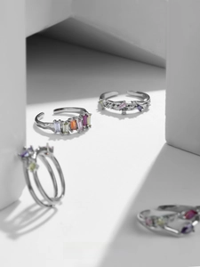 Detail of adjustable silver ring featuring vibrant rectangular rainbow zircon stones