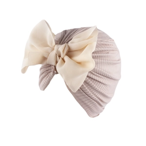 Detail of baby turban with soft ribbed fabric and large creamy white chiffon bow