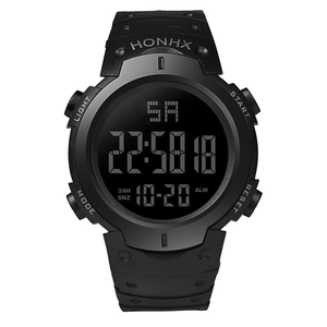 Macro shot of large digital display and black silicone strap on sport watch