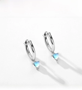 Close-up of S925 silver hoop earrings with heart-shaped blue moonstone charms