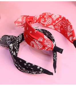 Detailed close-up of paisley pattern fabric headbands with bunny ear knot design
